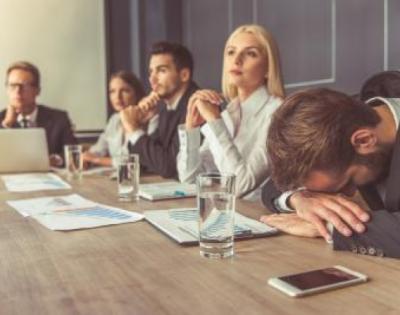 coworkers in a meeting looking bored