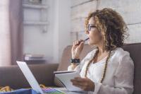 woman writing on a computer